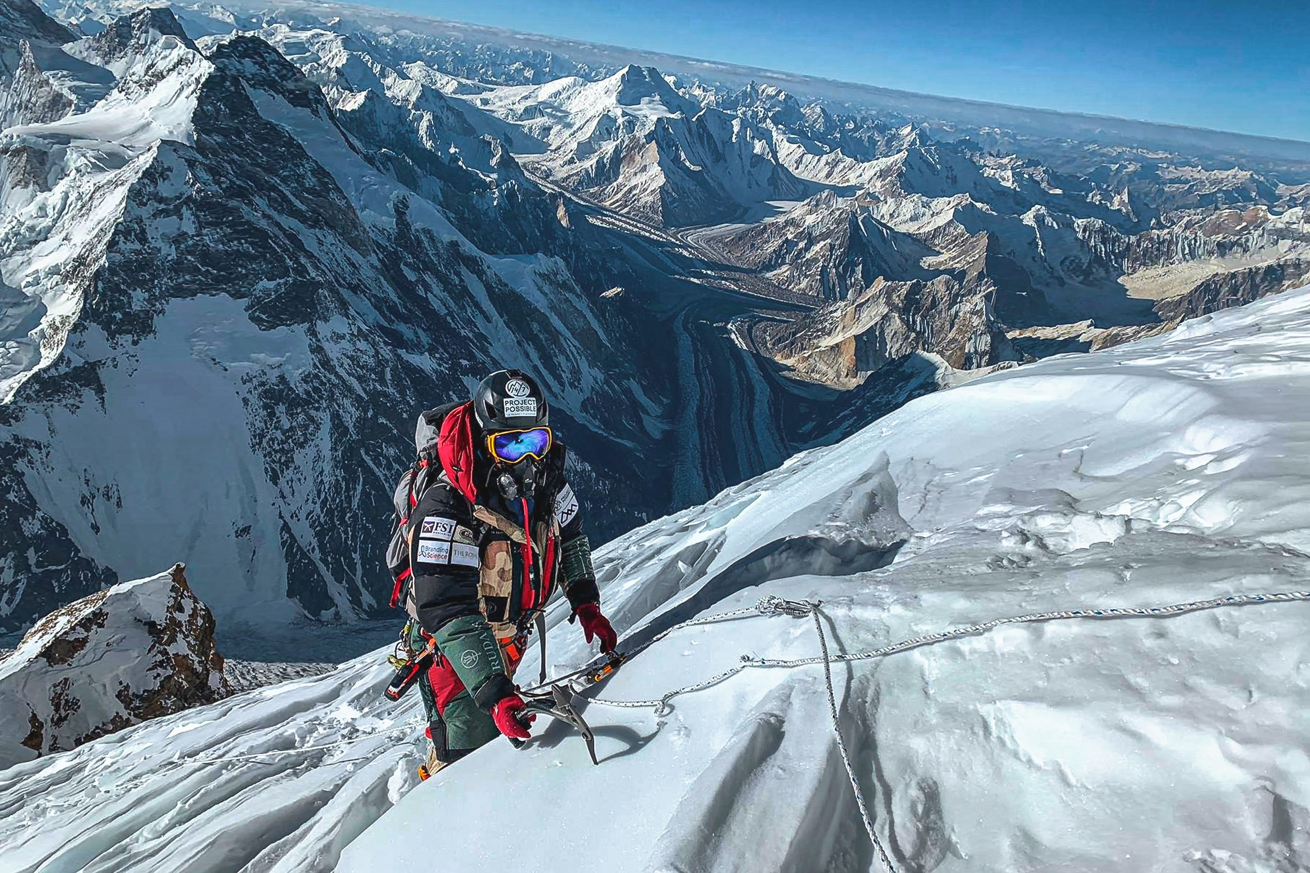 Nimsdai Purja MBE pictured climbing K2 in summer 2019 with the magnificent Baltoro Glacier below.