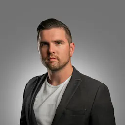 Photo by Tony Luginsland on Unsplash: https://unsplash.com/photos/a-man-in-a-suit-posing-for-a-picture-bbOOTiq-EPA