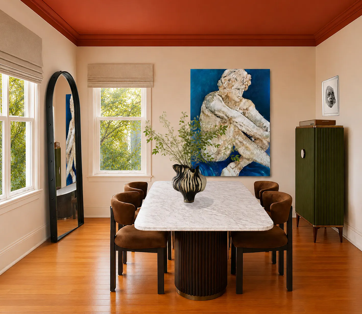 dining room with large marble table and a large blue painting of a greek sculpture. a green cabinet on the right and windows and a floor tall leaning mirror in a black frame on the left.