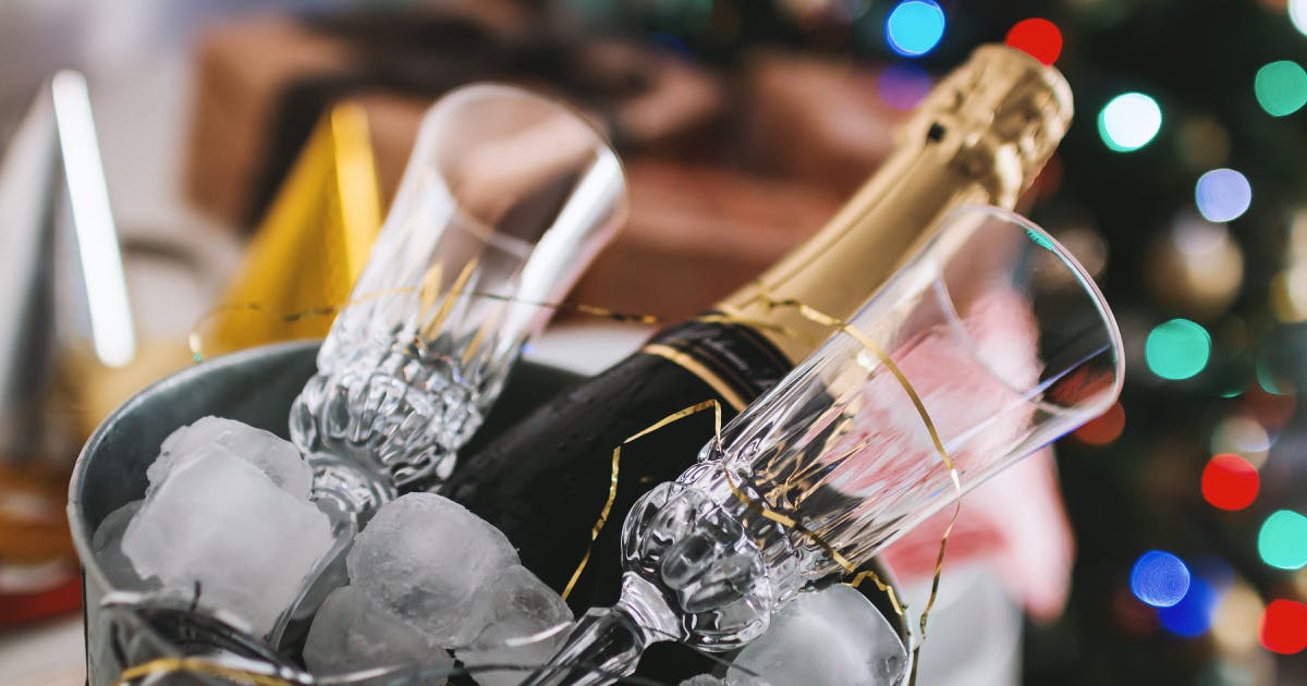 Champagne and flutes in front of Christmas Tree
