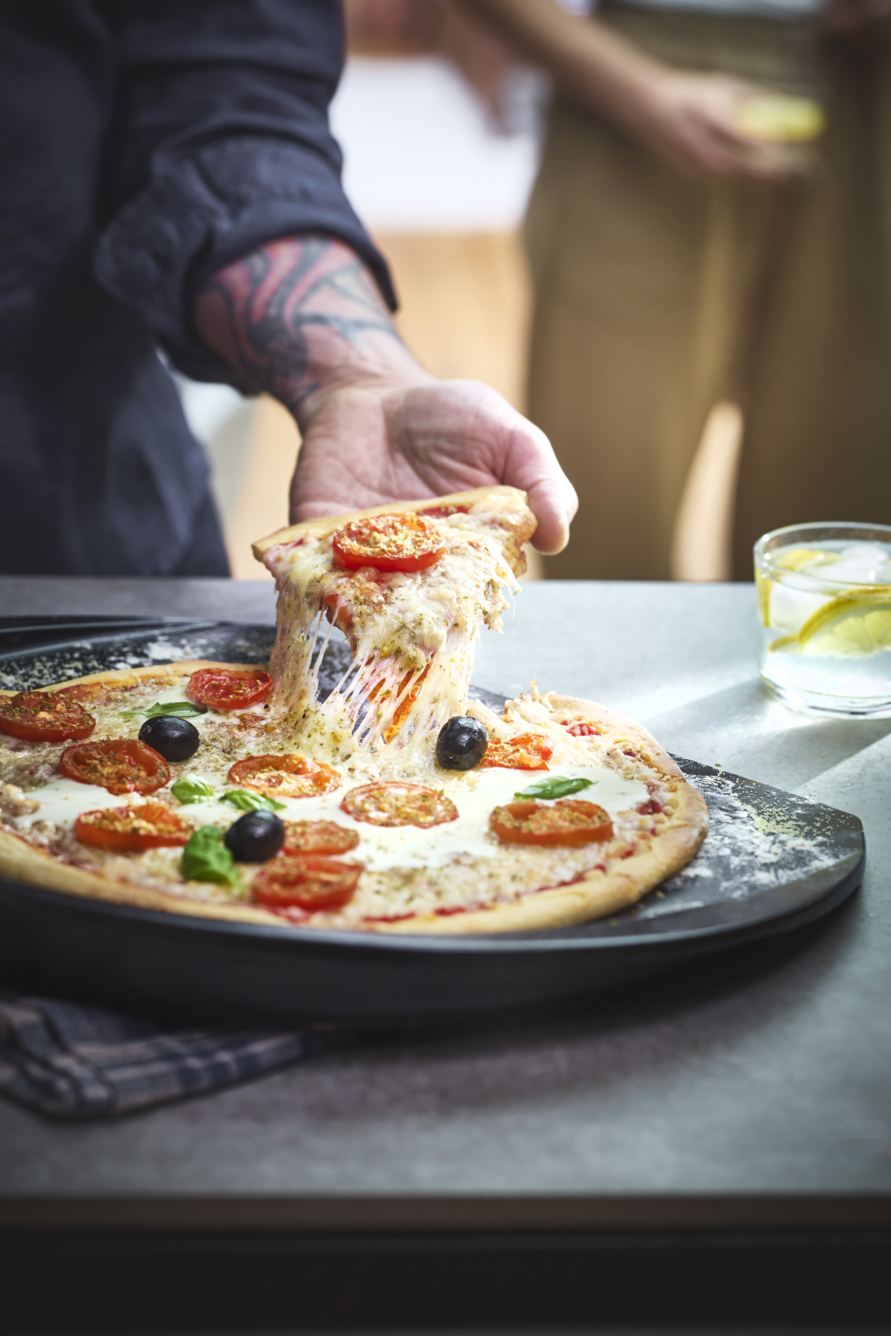 Pizza with cured ham, burrata and basil