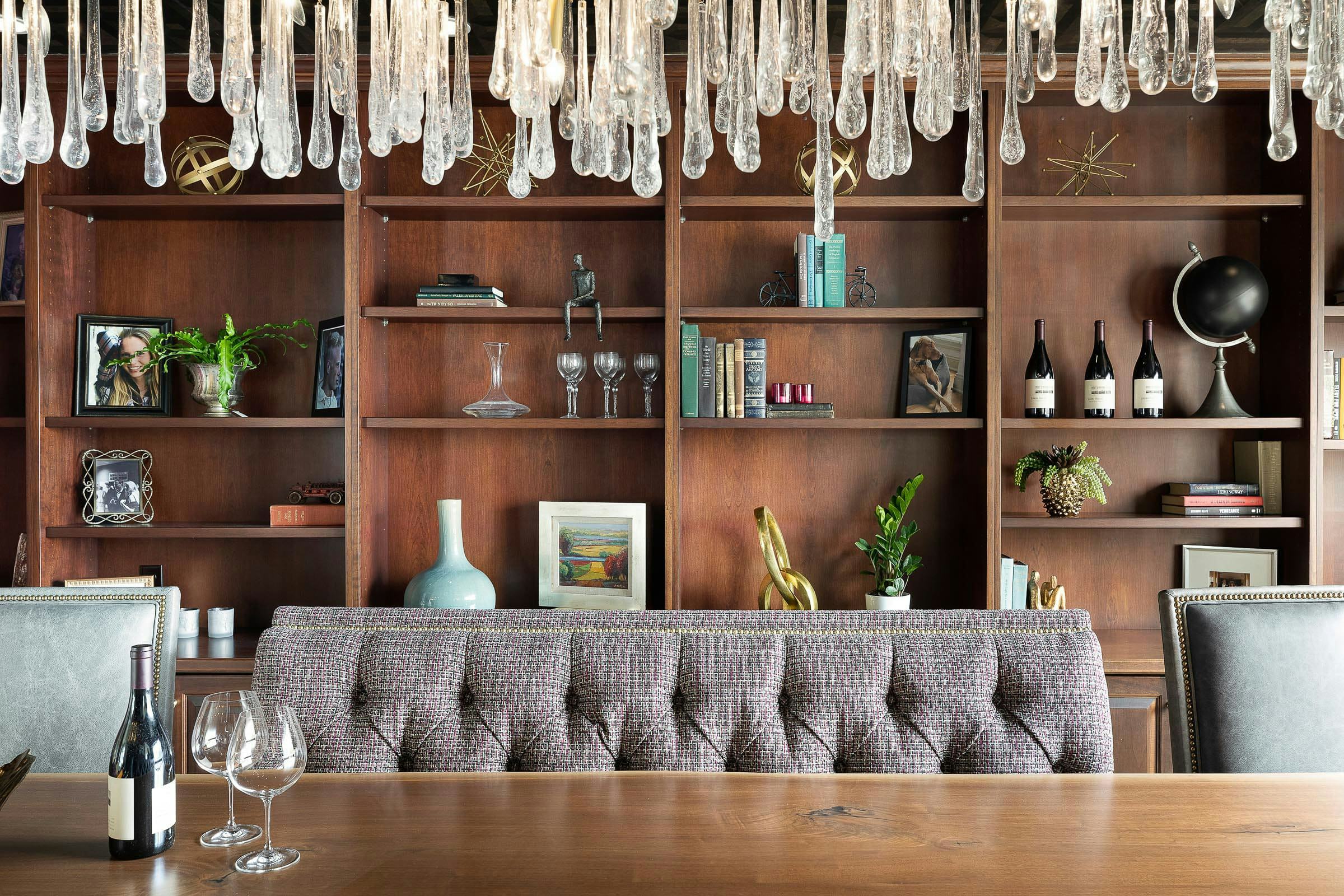 tasting room with banquette style seating, contemporary crystal chandelier with teardrop design