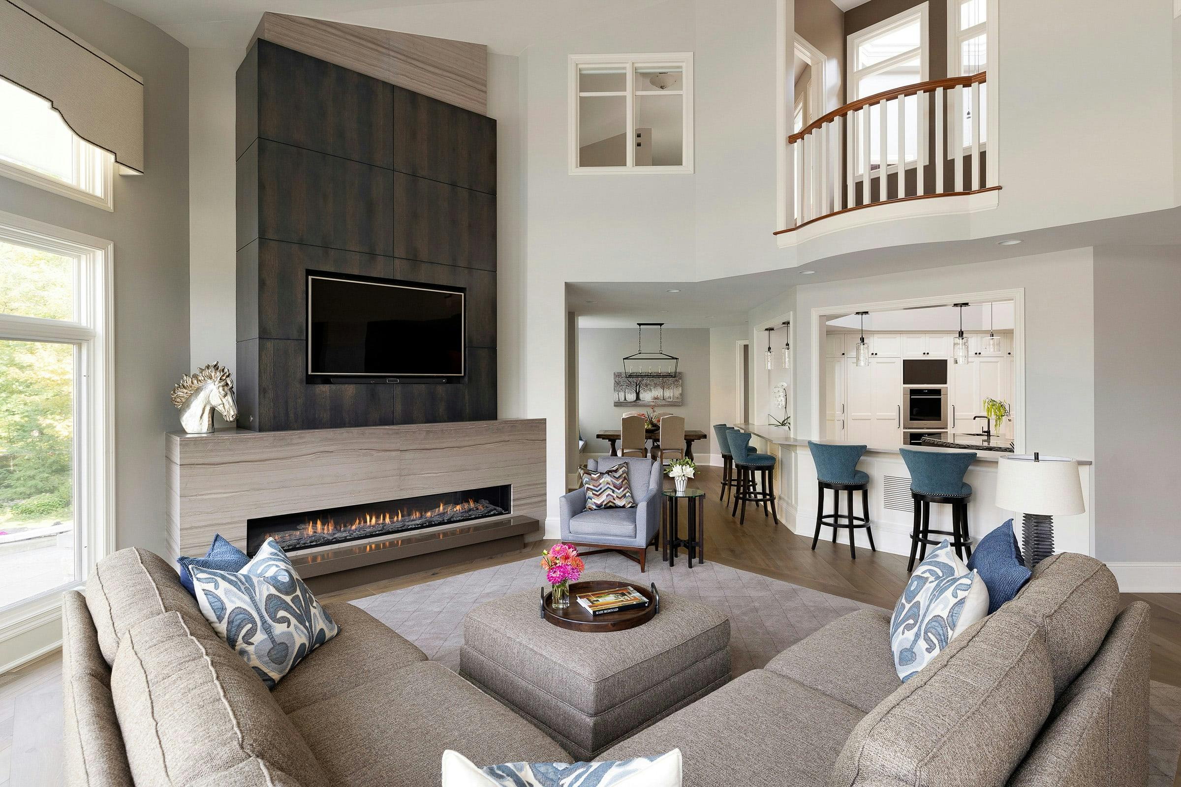 living room with sectional, fireplace, high ceilings
