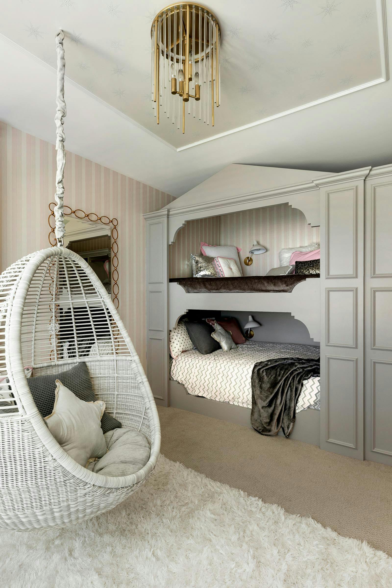 Chandelier inset stair wall paper, subtle stripe on the walls.