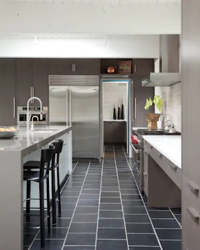 kitchen, sink, black tile, large refrigerator and the entry to the pantry