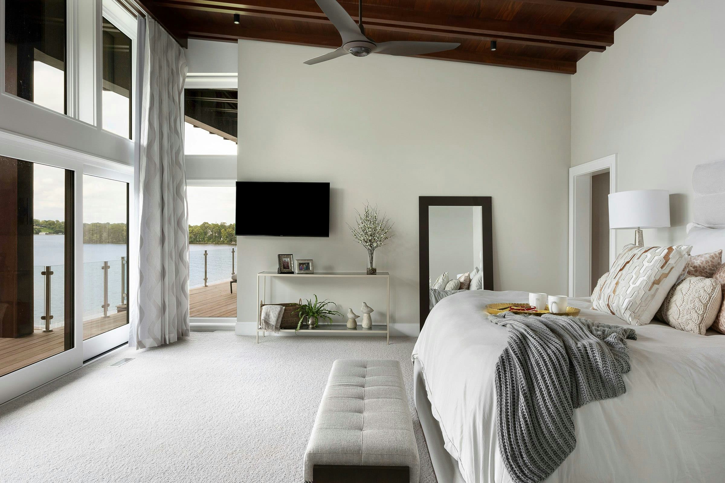 neutral bedroom with tall ceilings and windows