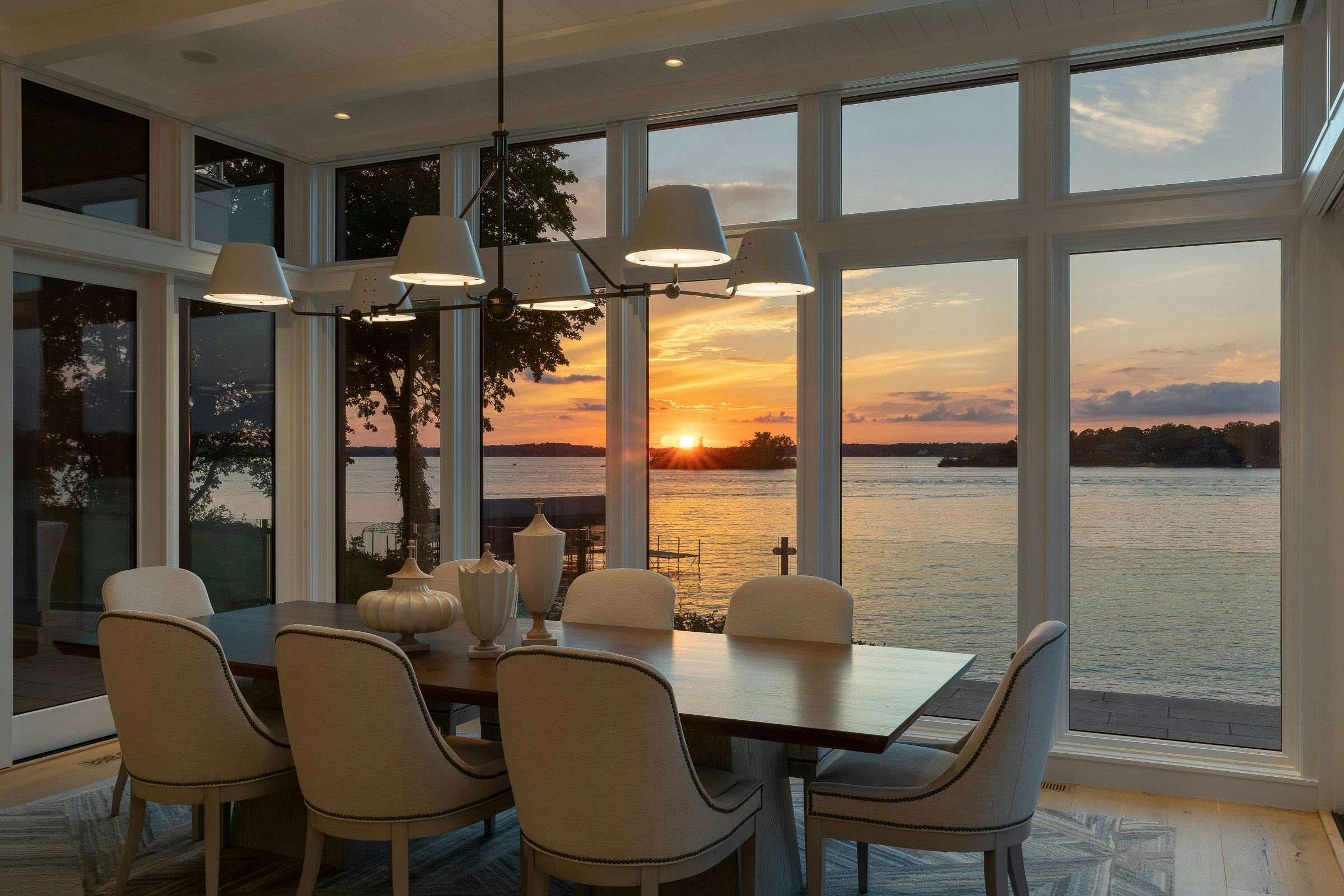 dining room with view of lake and sun setting