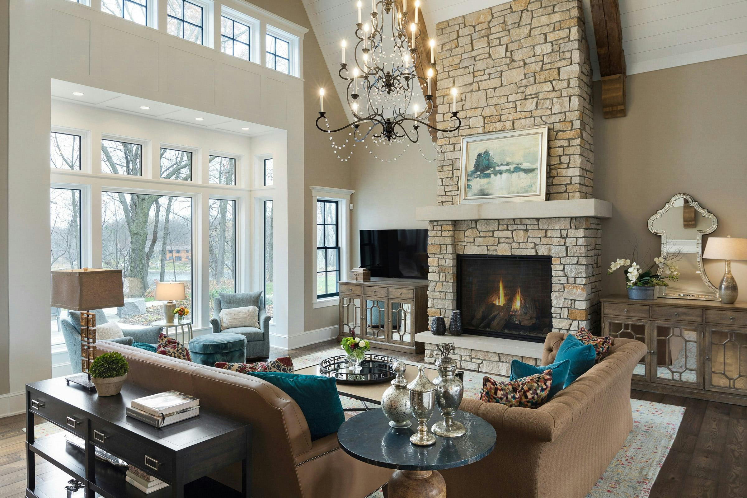 great room overlooking lake with sofas, chandelier