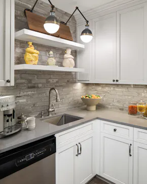 pantry with dishwasher, sink, white cabinets
