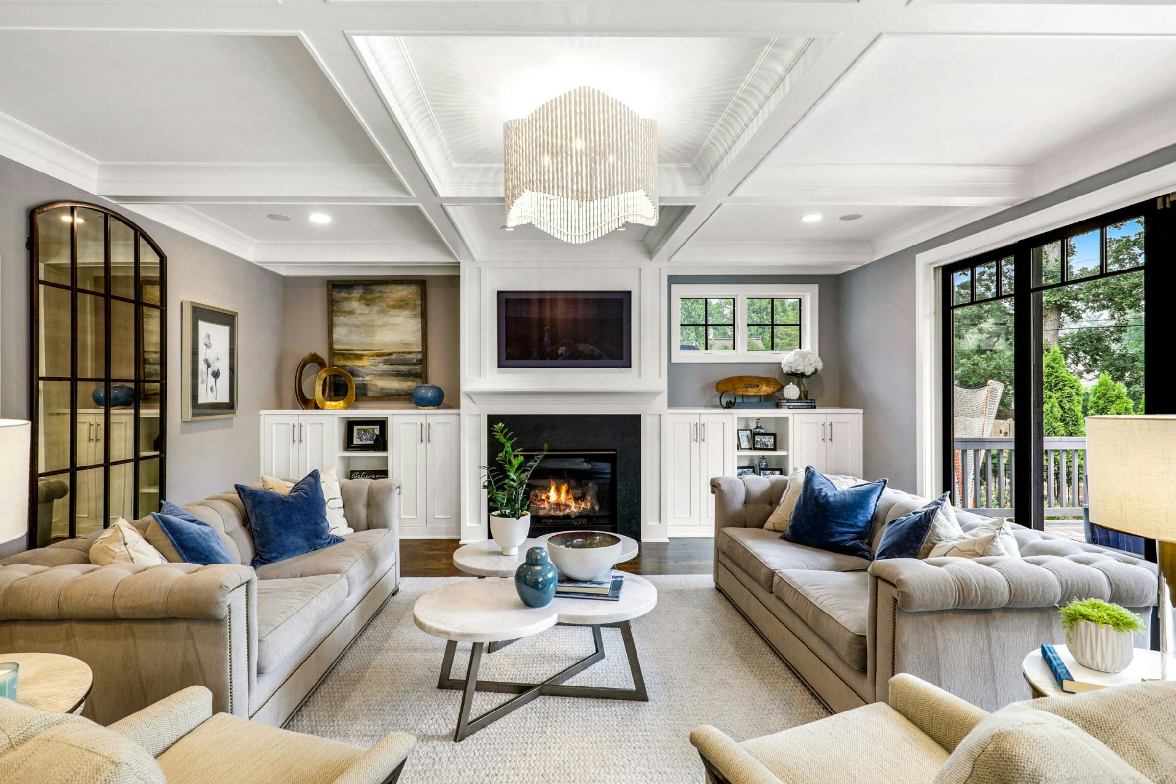 neutral living room with TV and fireplace