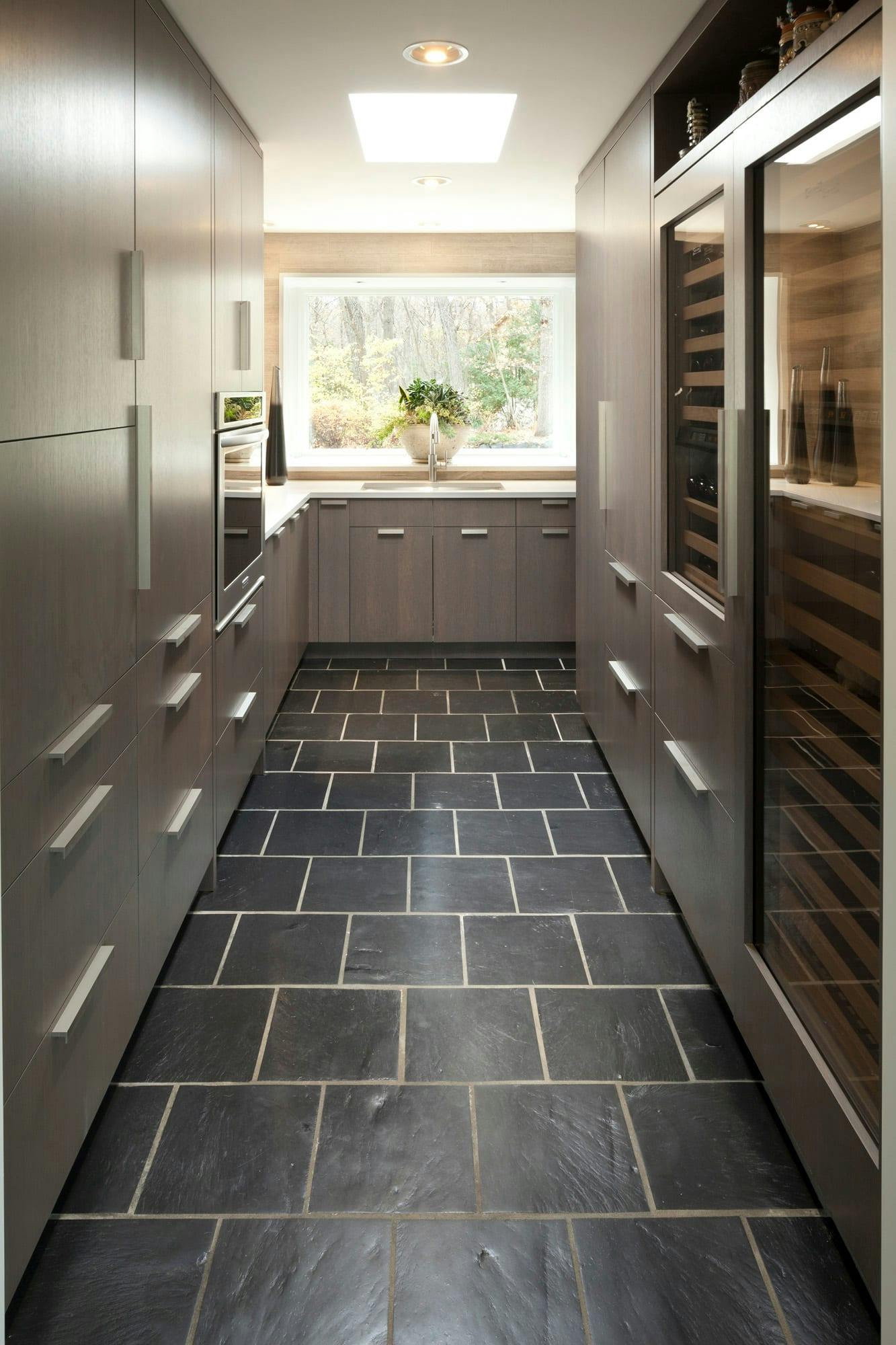 modern pantry with cabinets and stainless steel appliances