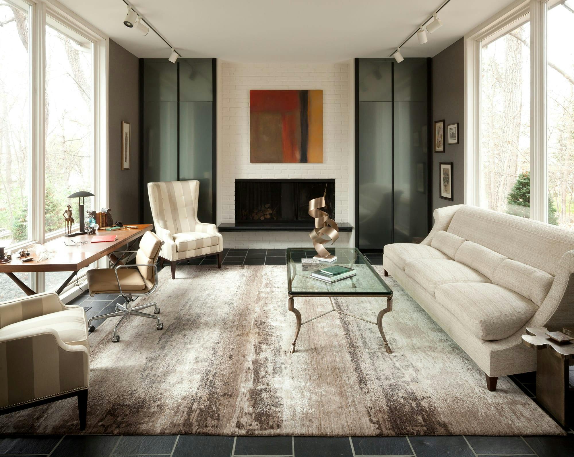 sitting room with couches, large windows, desk for playwriting