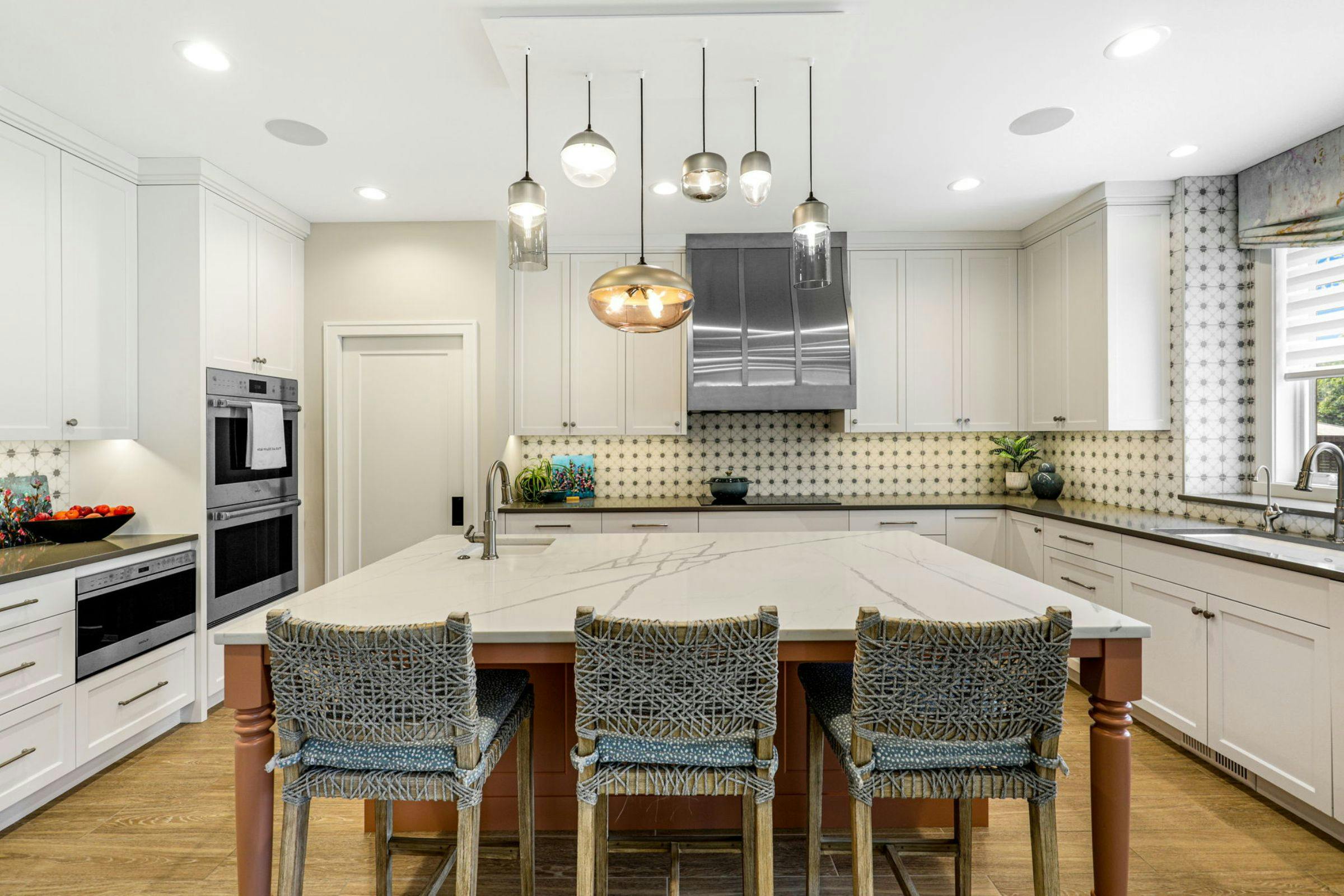 large island with three chairs in a white kitchen