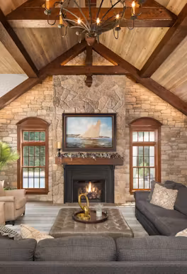Residential Renovation with stone fireplace and ceiling with wood beams