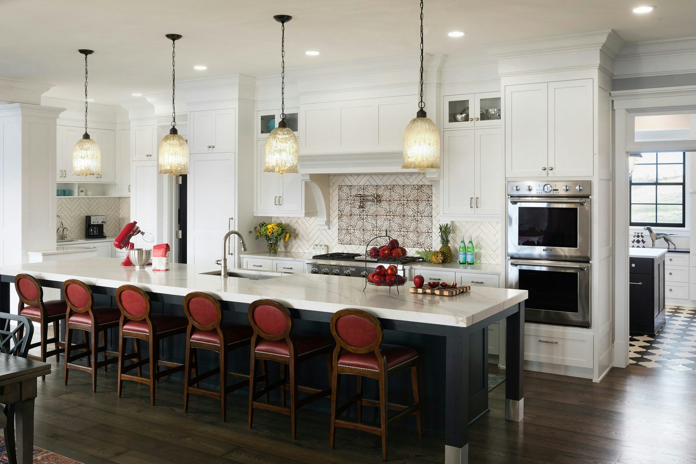 large black and white island, red barstools