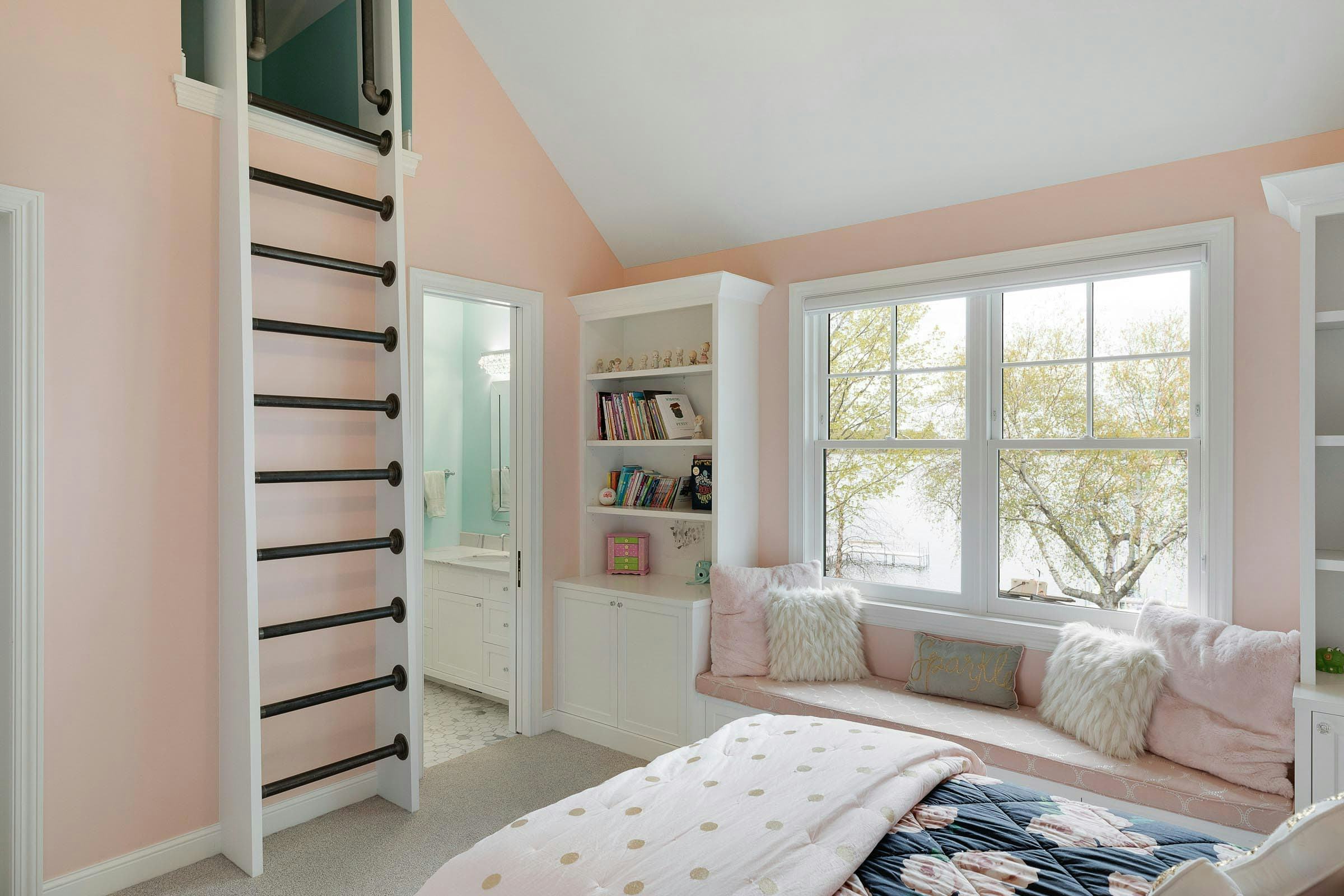 pink children's room with ladder leading to the loft, custom built in storage