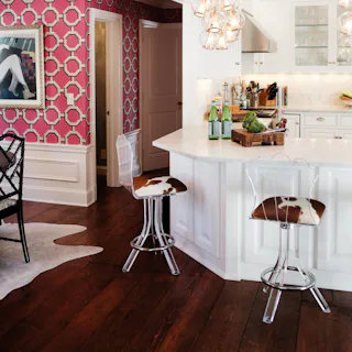 white kitchen design with cowhide chairs