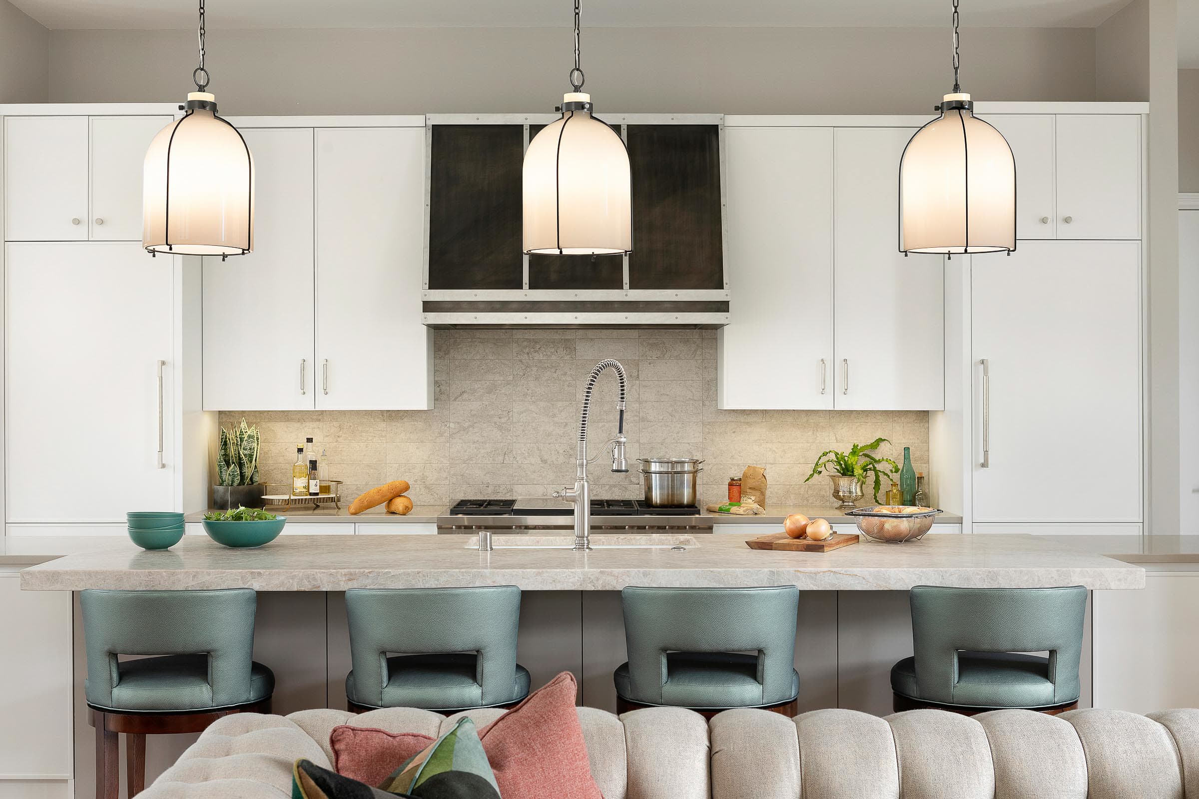 large island with teal bar stools, gray cabinets