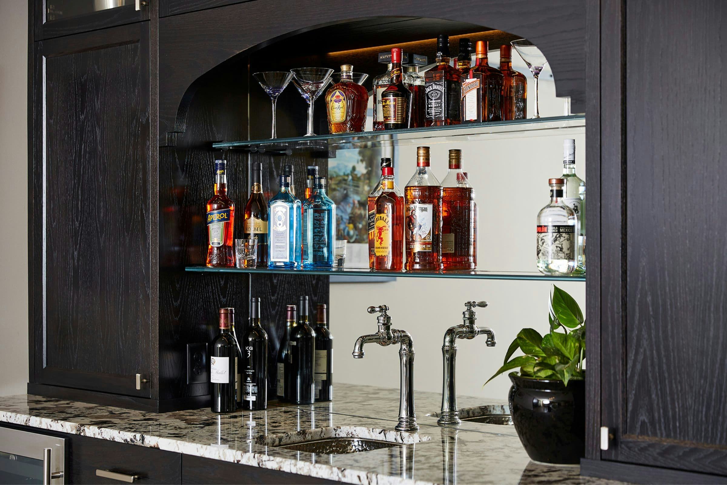 mirrored-back and glass display shelves with liquors and glasses