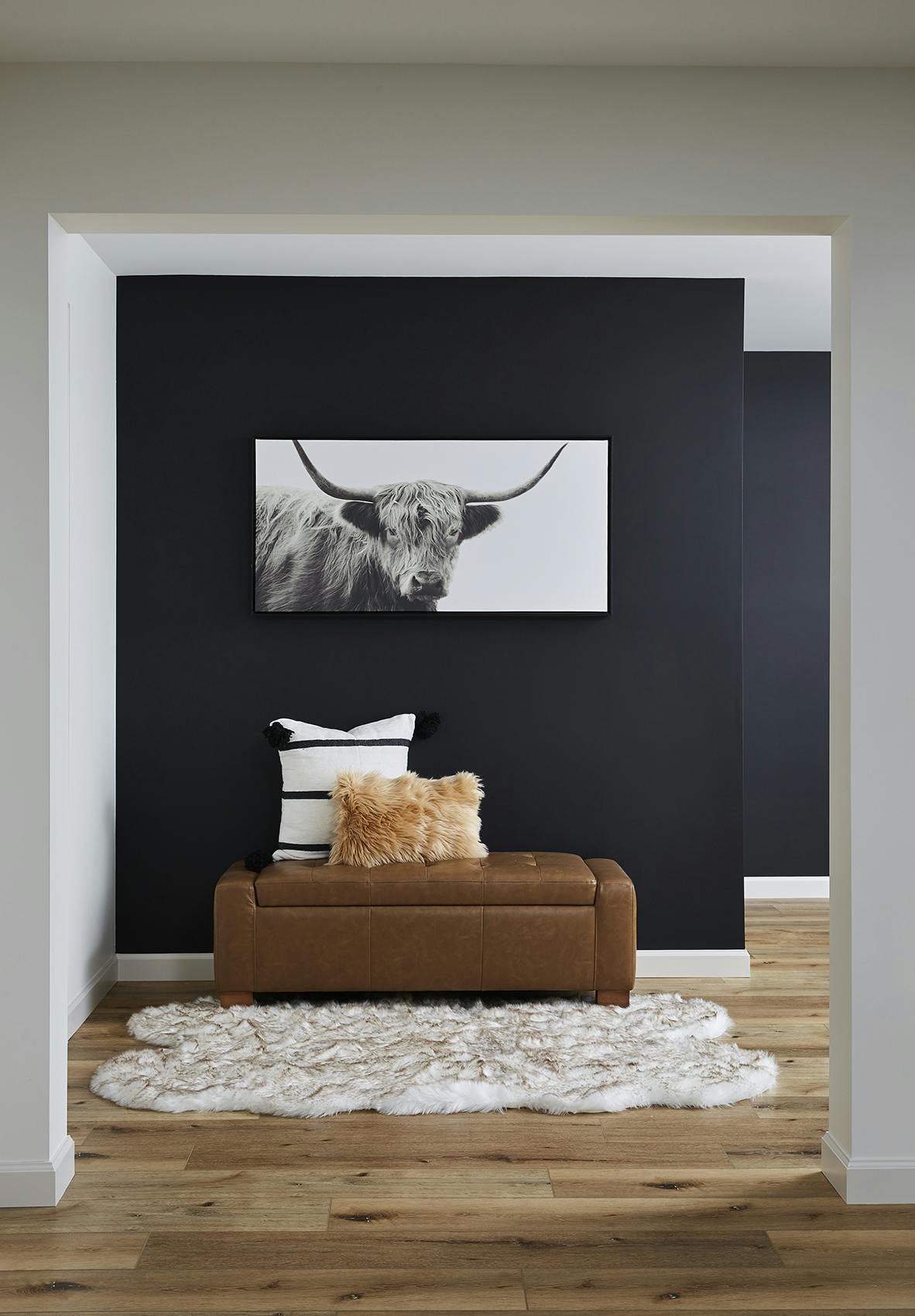 hallway with black accent wall leather ottoman storage