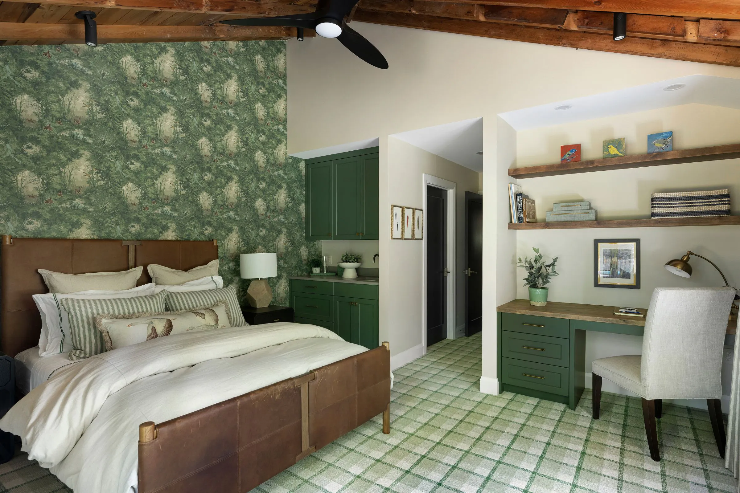 Rich green built-in cabinetry and patterned wallpaper in Wisconsin cabin bedroom