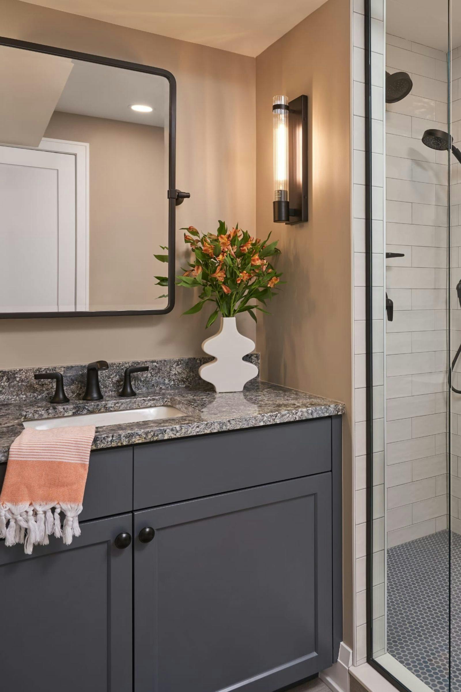 A vanity styled with a vase and a blush towel