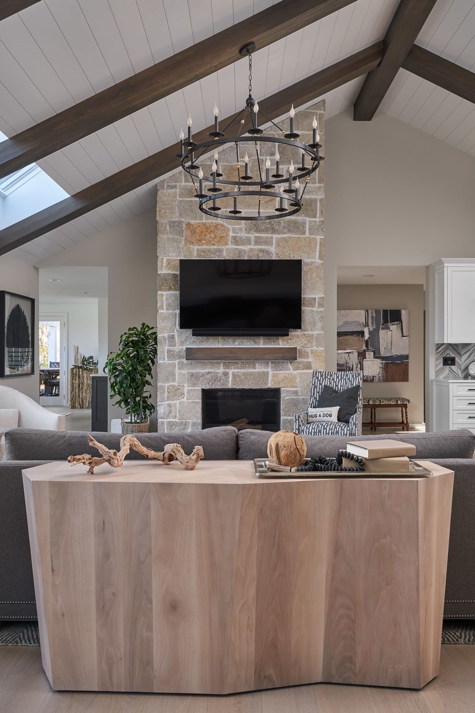 stacked-stone fireplace, beam ceiling