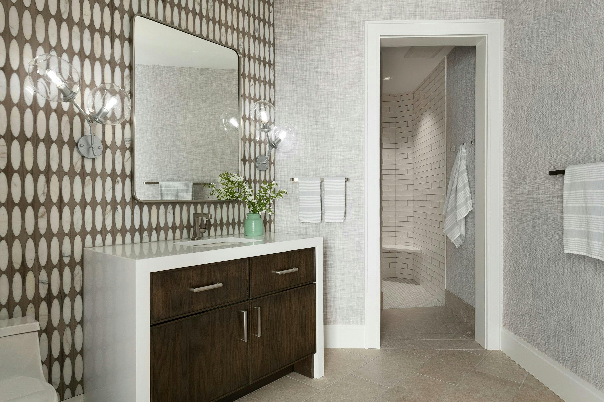 feature wall behind a wood and white vanity 