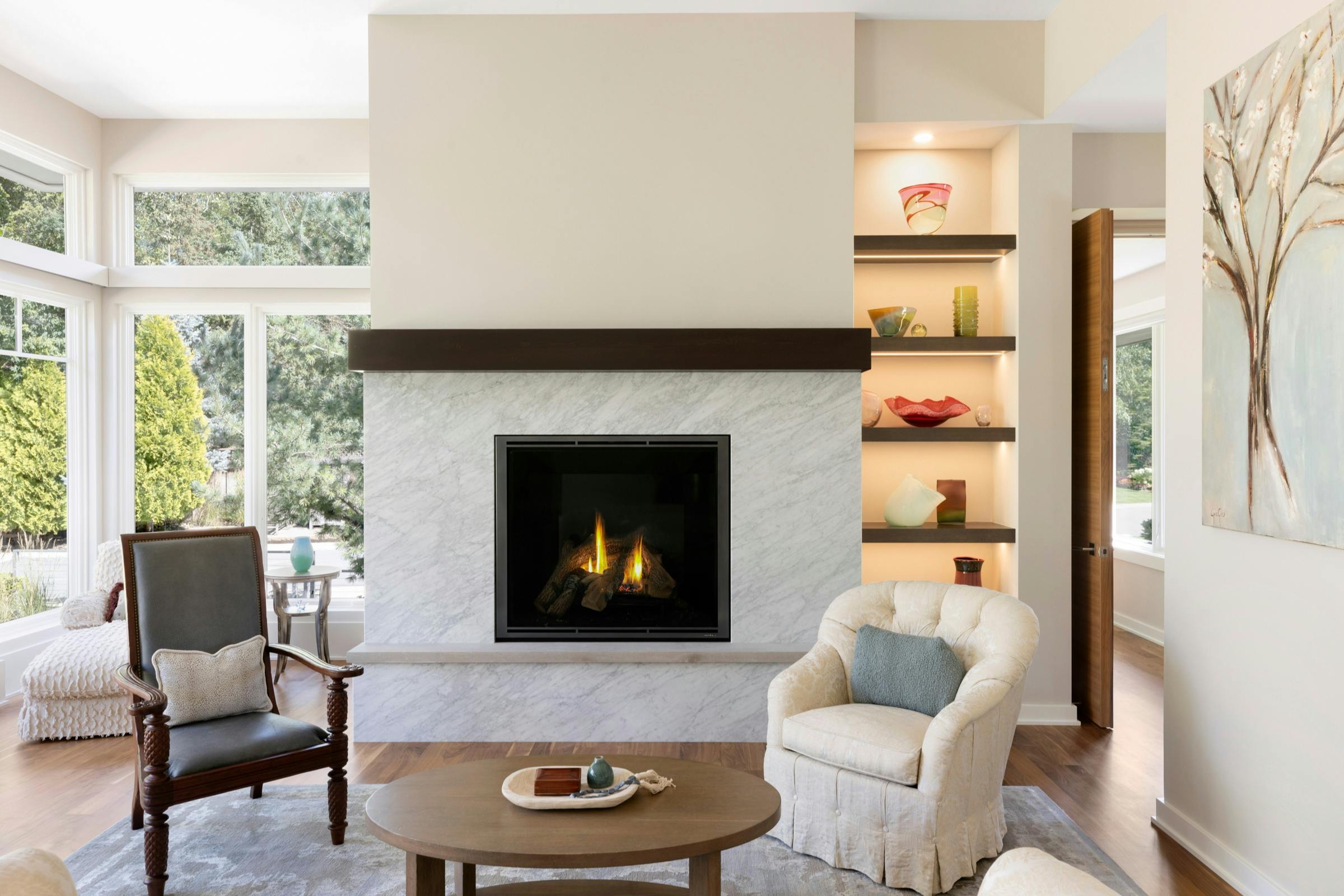 marble fireplace with lit display shelves with decor