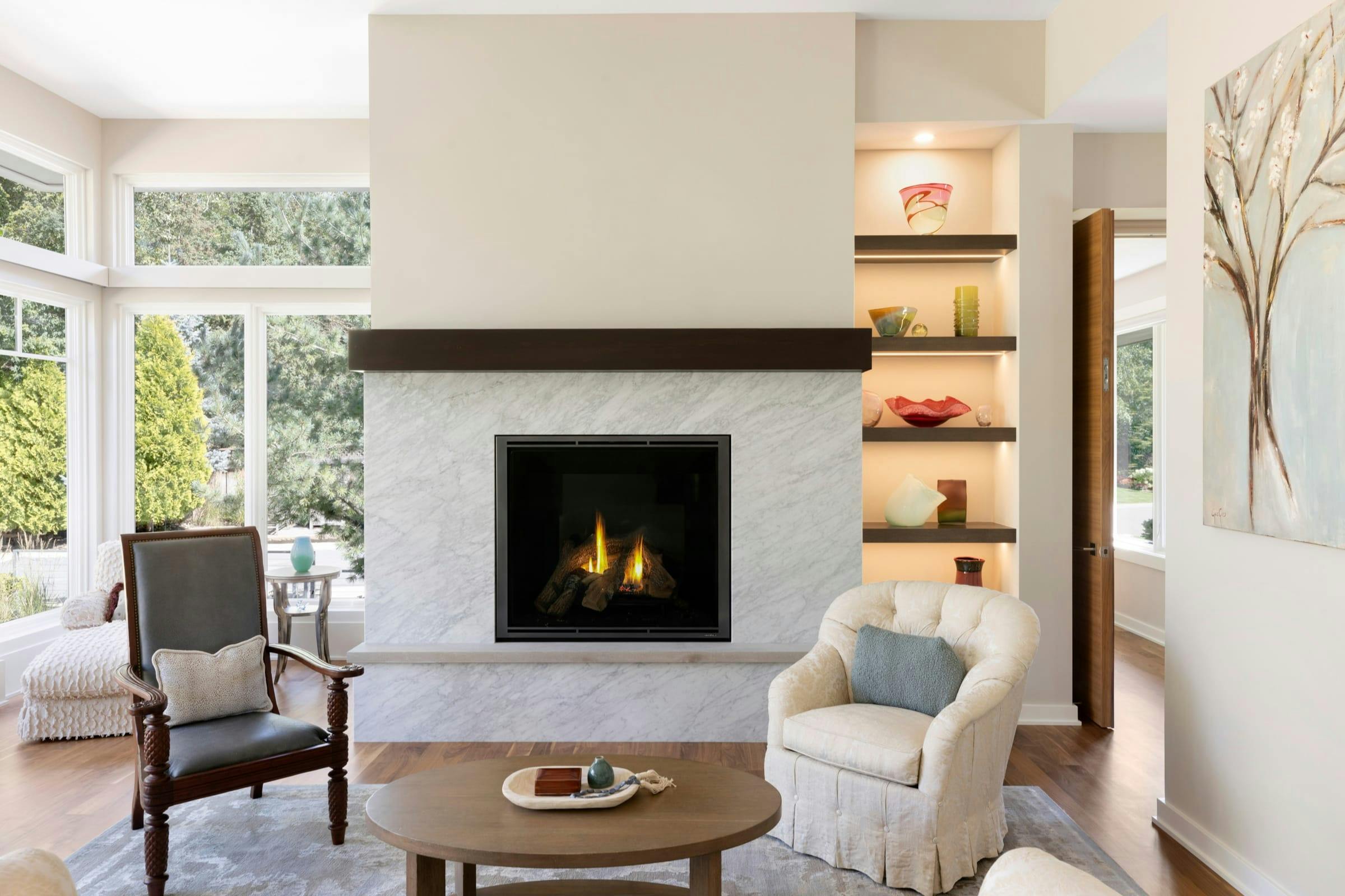 living room with fireplace and shelves with accent lighting