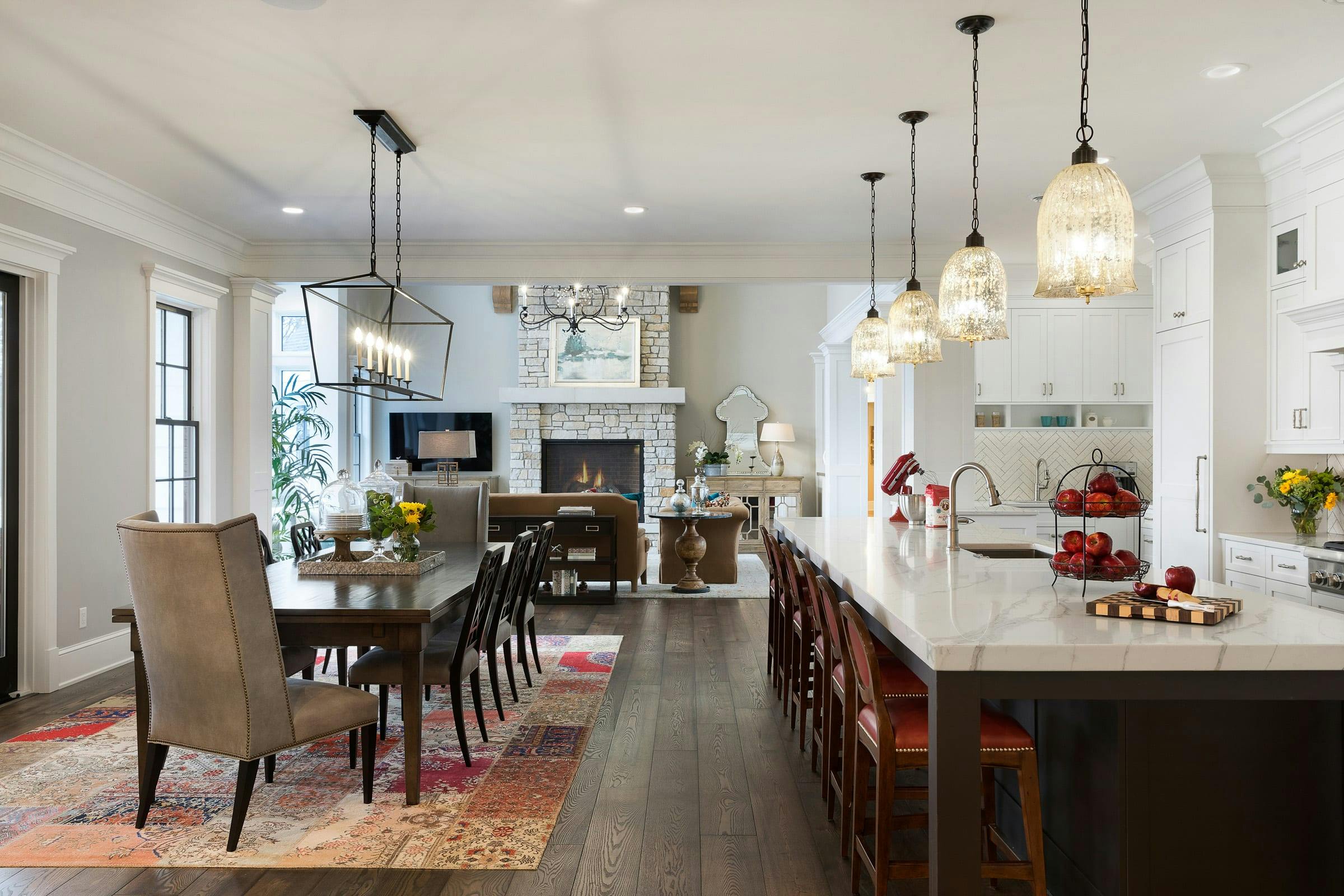 kitchen island, dining and chairs and in background, the great room