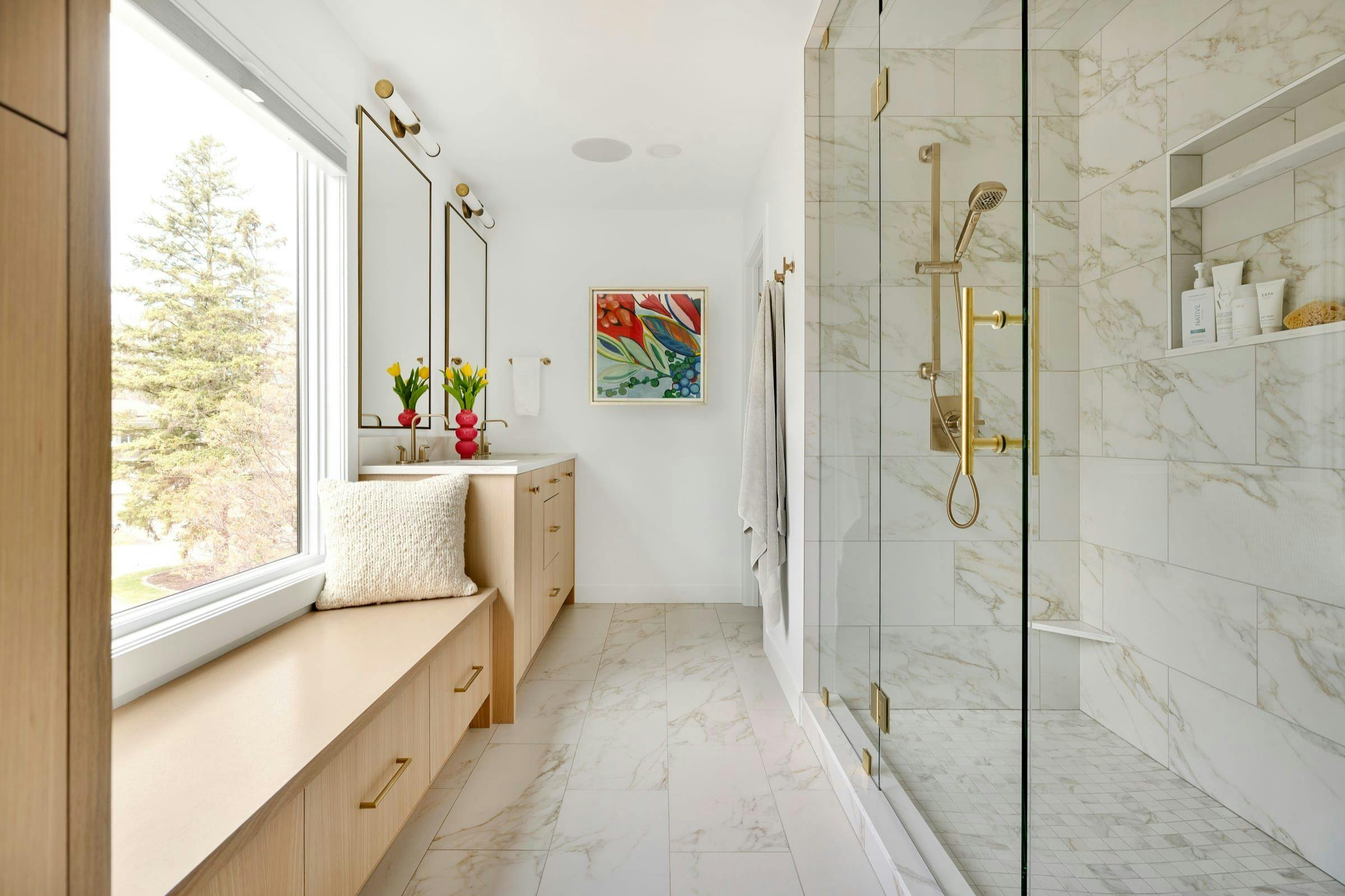 light and bright primary bath with window and bench