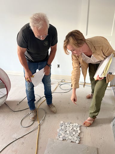 designer looking at tile with man