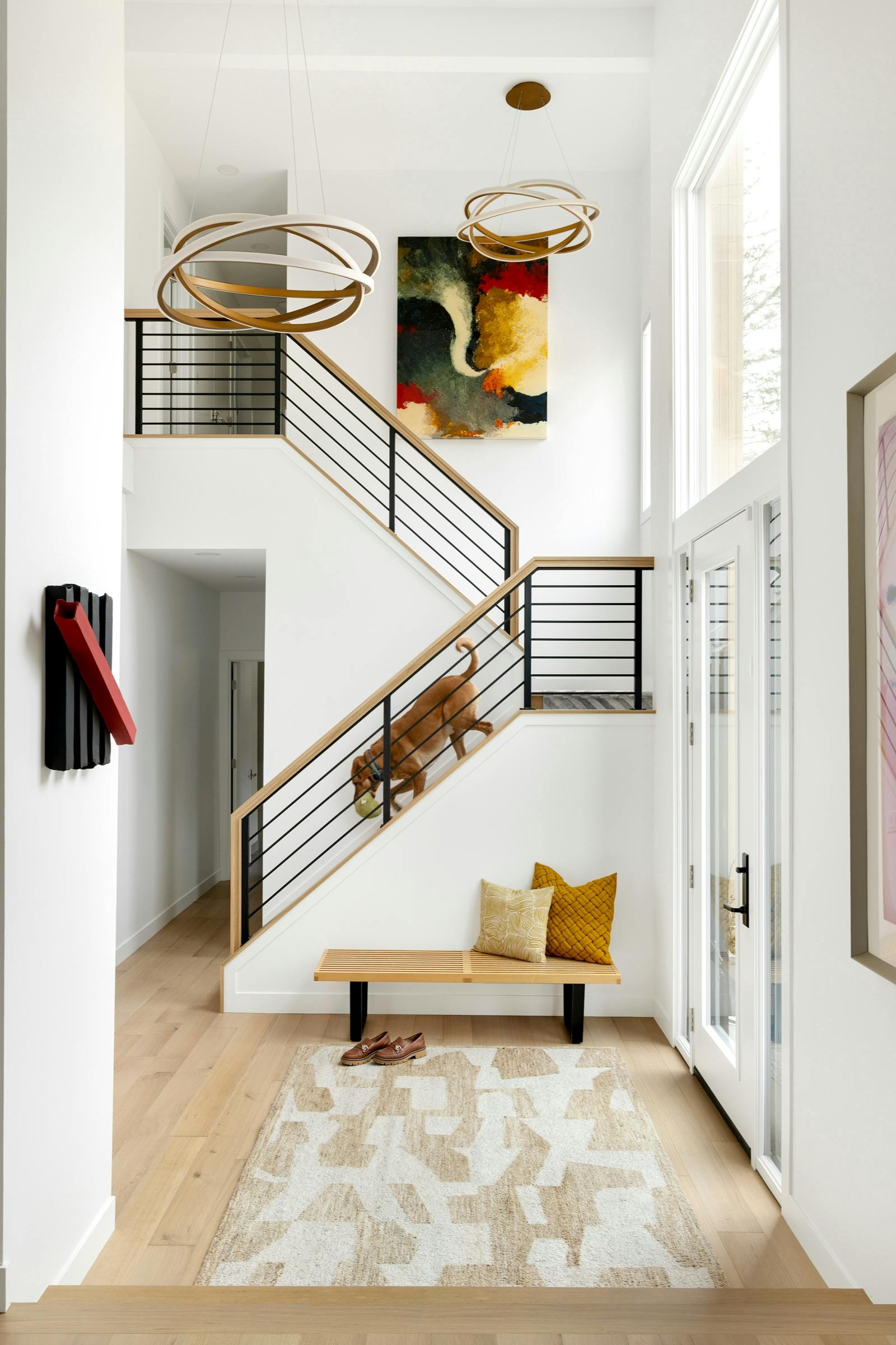 entryway and stairs with metal railing