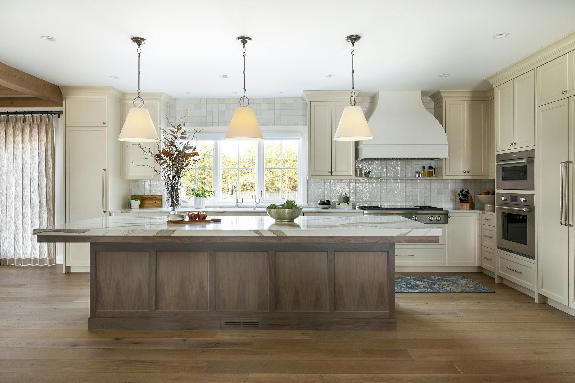 Kitchen design with central island, relocated appliances, and cohesive finishes