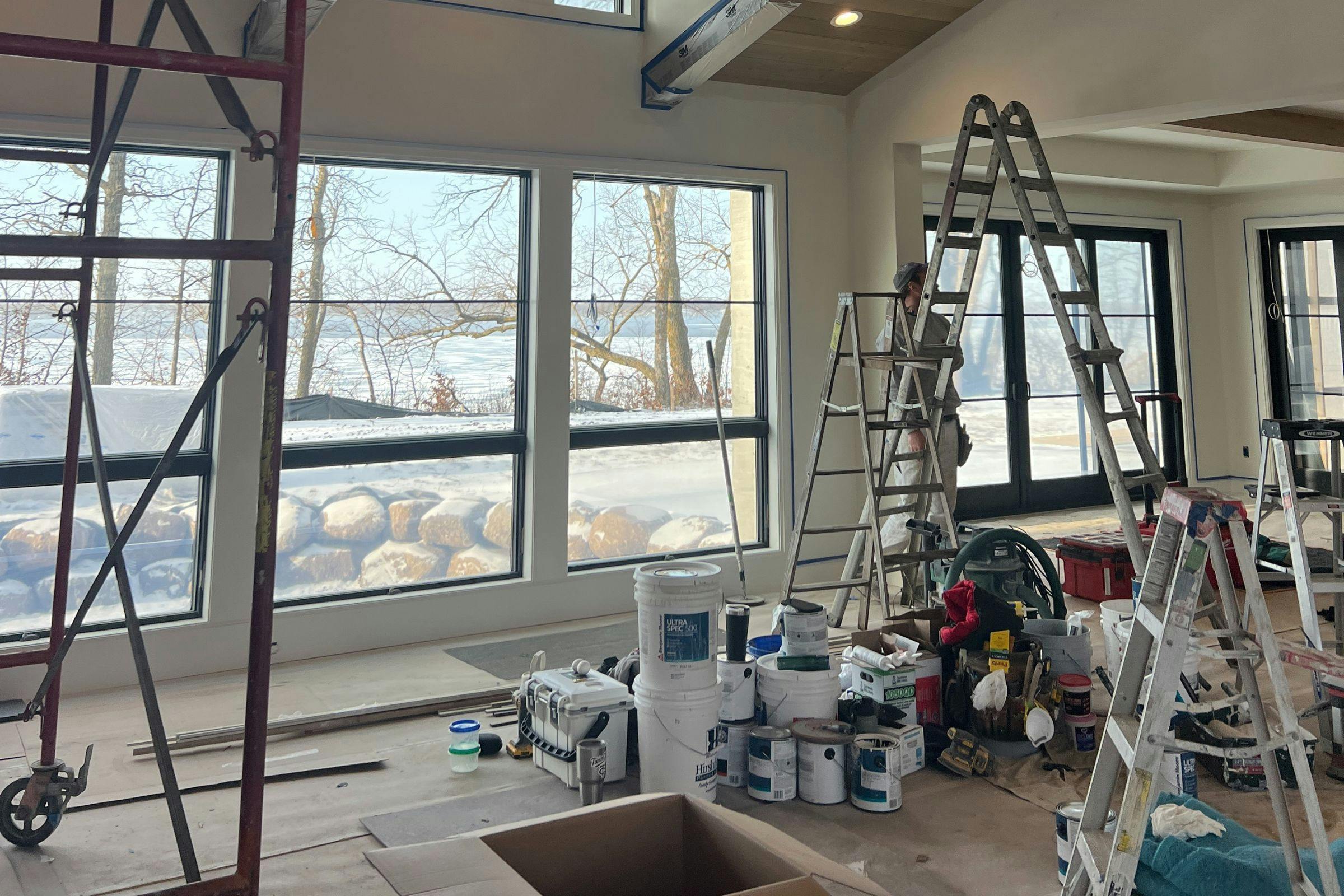 ladder and construction worker in a space undergoing a remodel