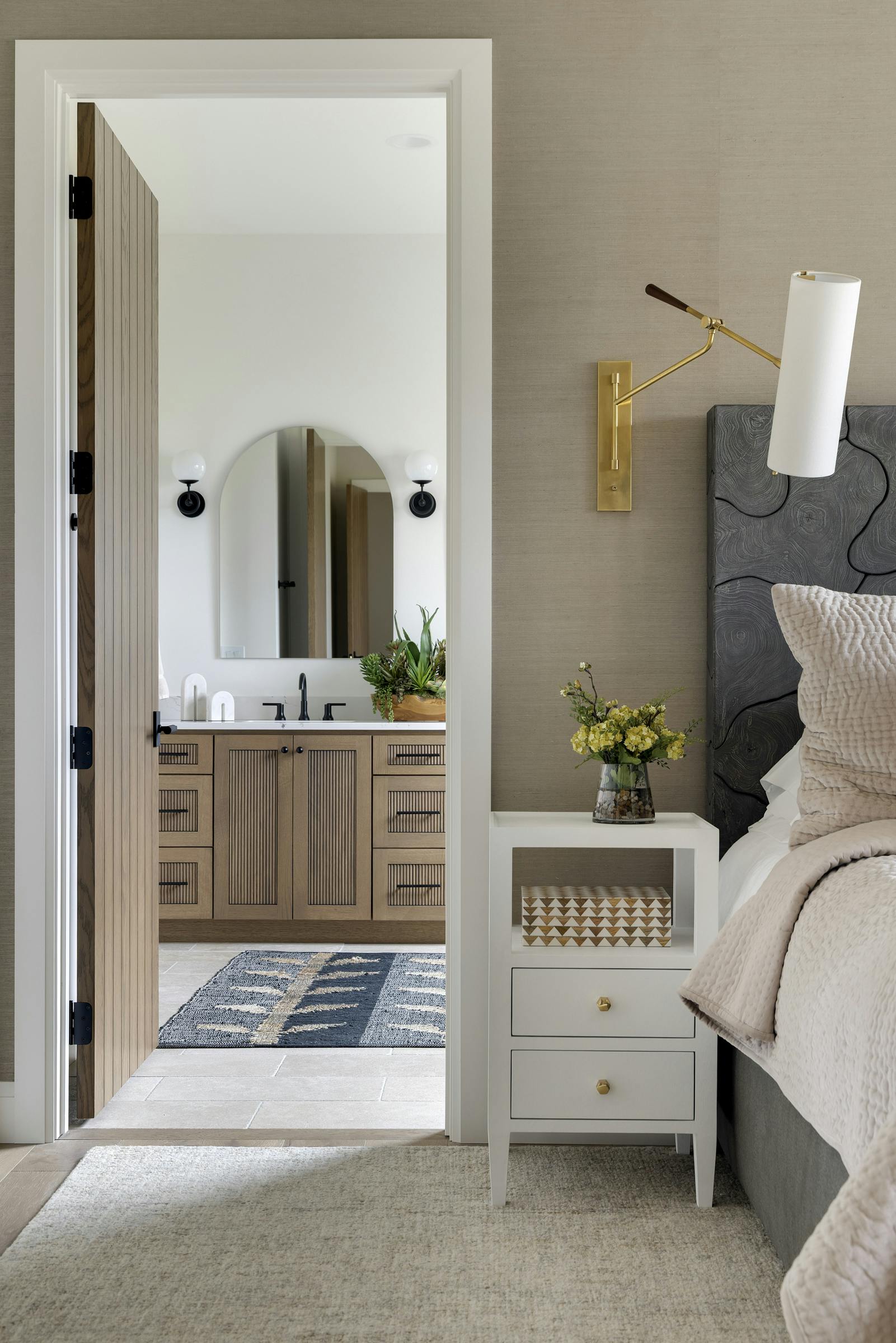 doorway looking into a primary bathroom suite