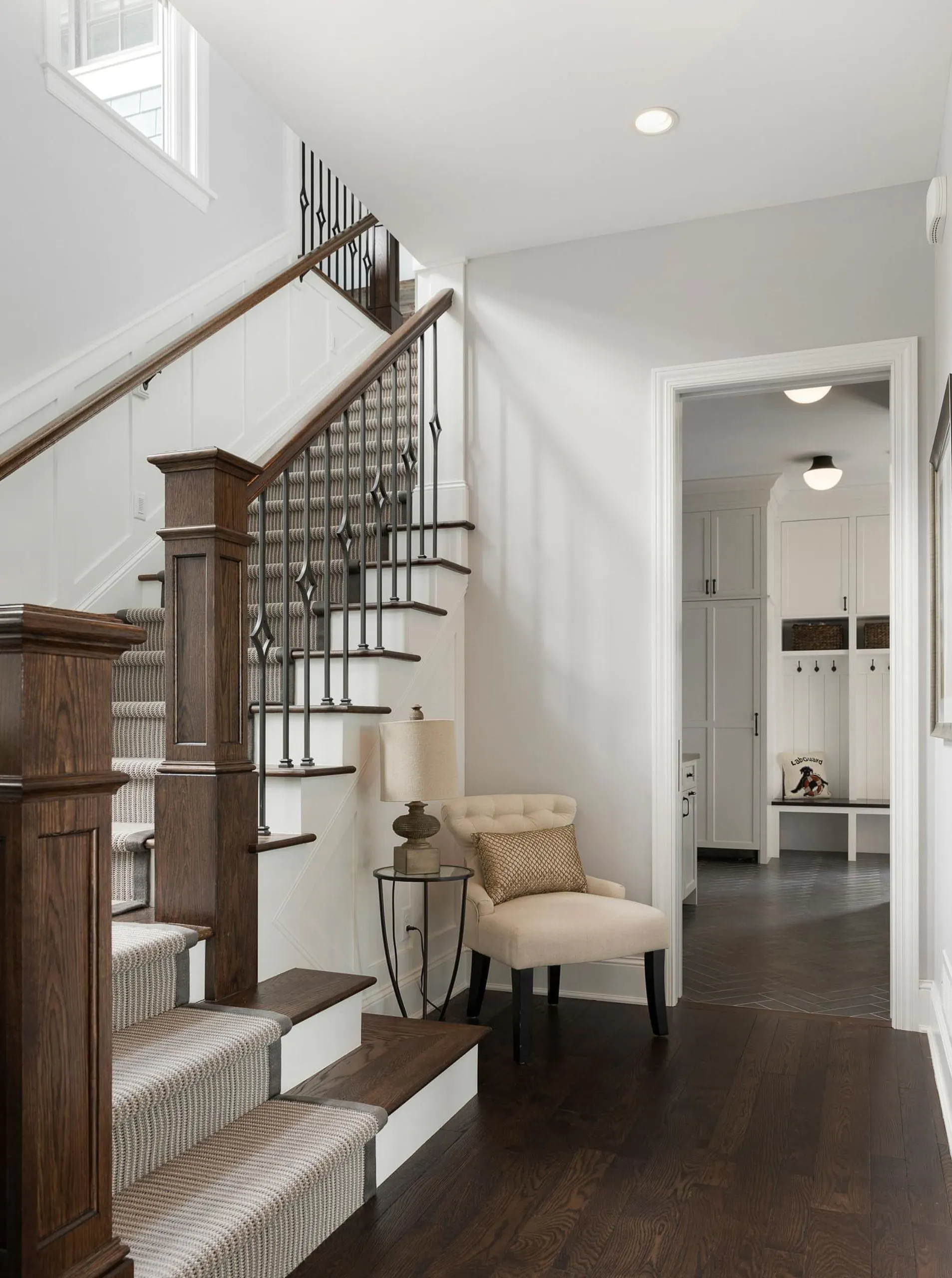 Stairwell with custom railing and architectural detailing in a whole-home remodel