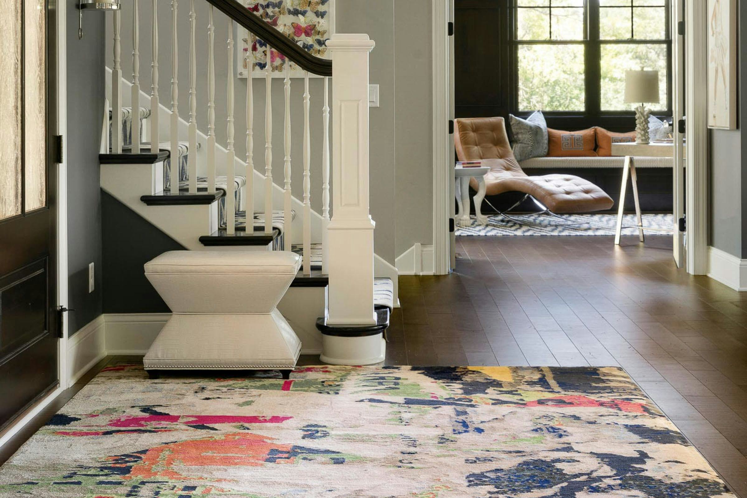 entryway with handwoven abstract rug, home office in the background