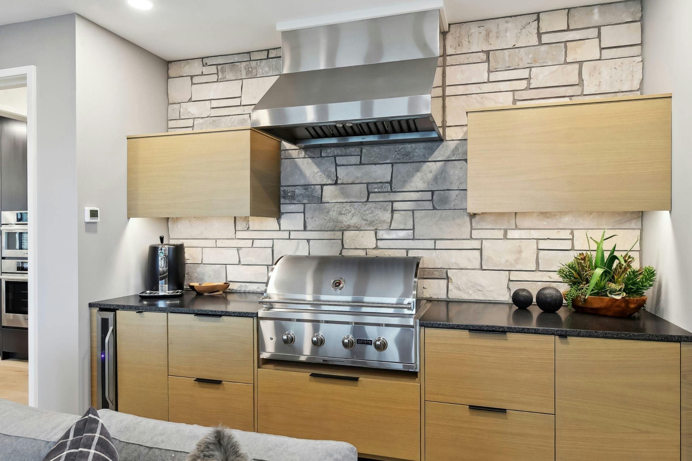 grill and vent along a stone backsplash