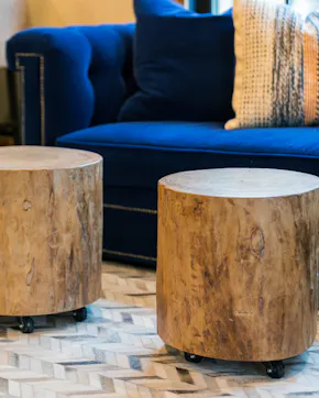 wood tables on castors, blue couch