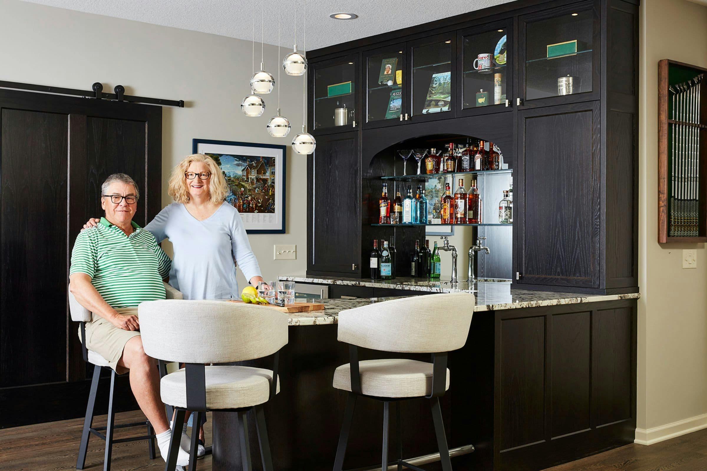 happy couple posing in front of new bar