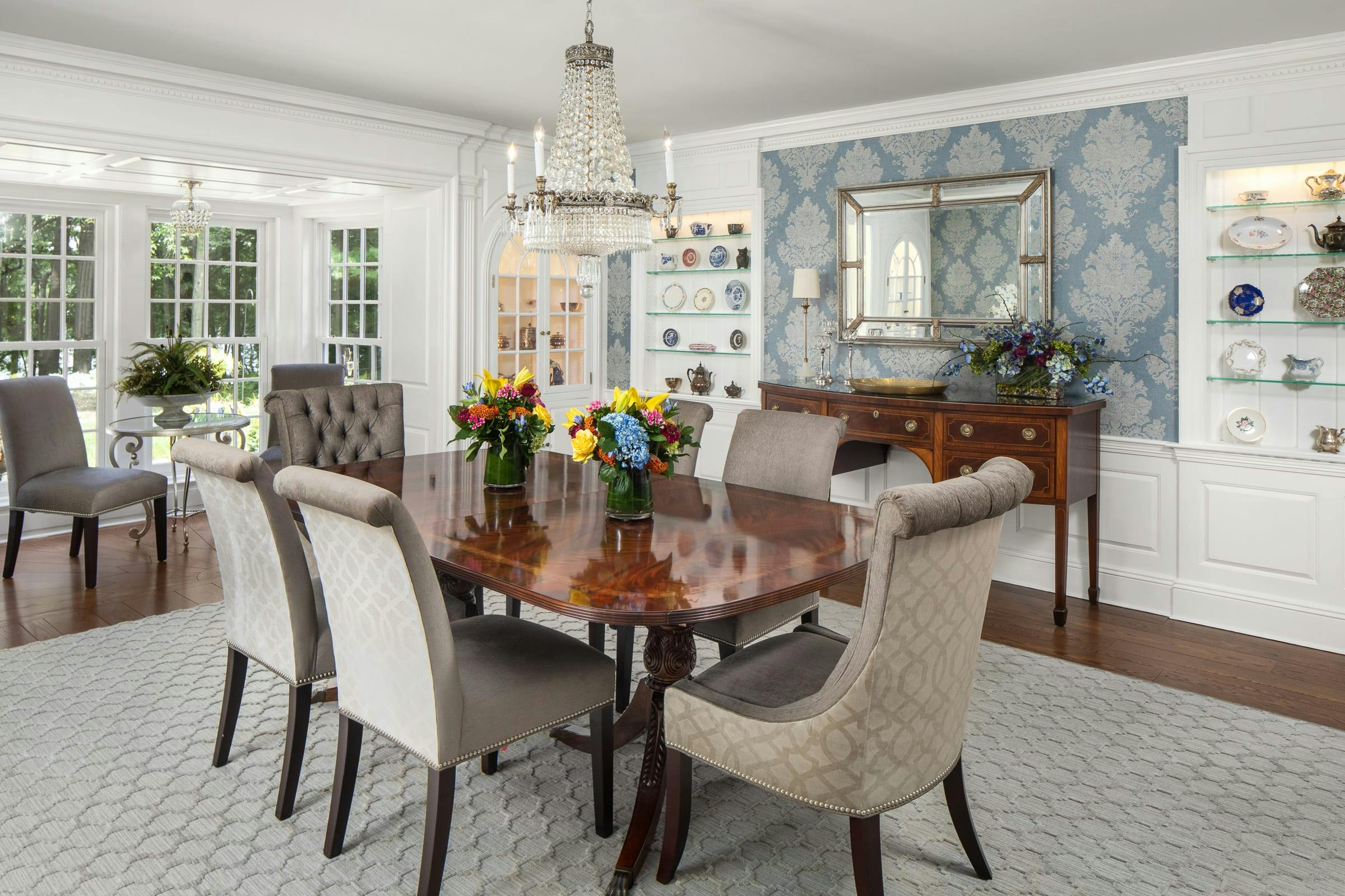 white dining room, table and chairs, glass display shelves