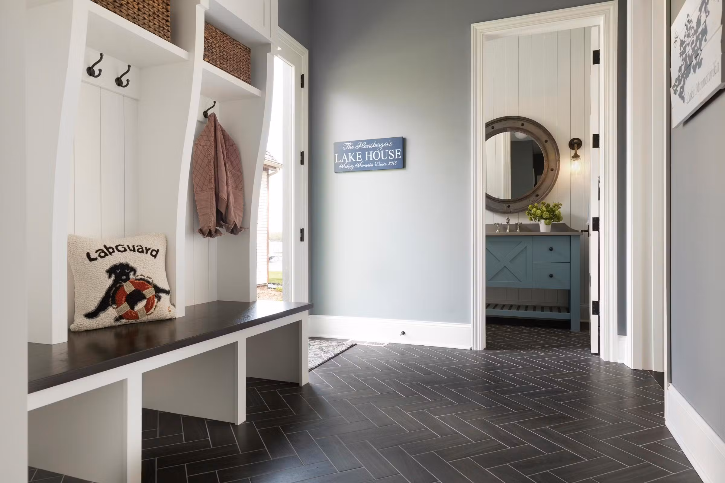 entryway that leads from the lake, bathroom off of the entry, durable flooring