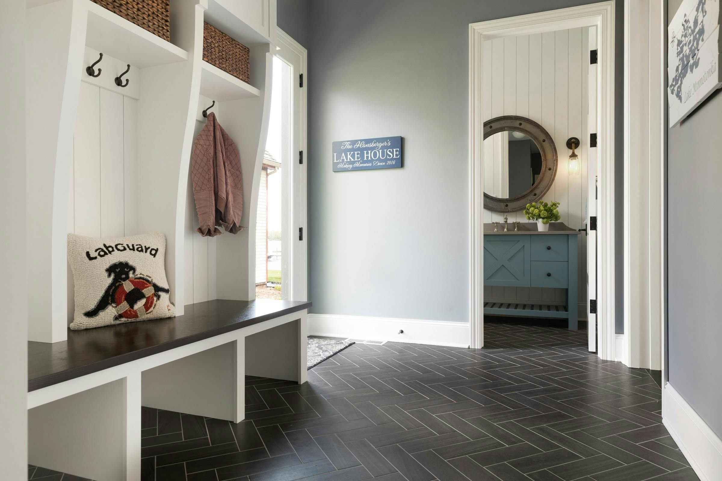 entryway that leads from the lake, bathroom off of the entry, durable flooring