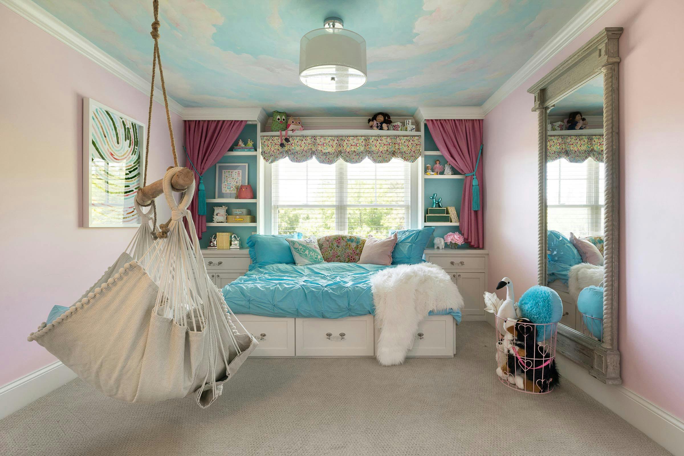 theatrical, pink daughter's room with hanging chair and faux painted ceiling of clouds