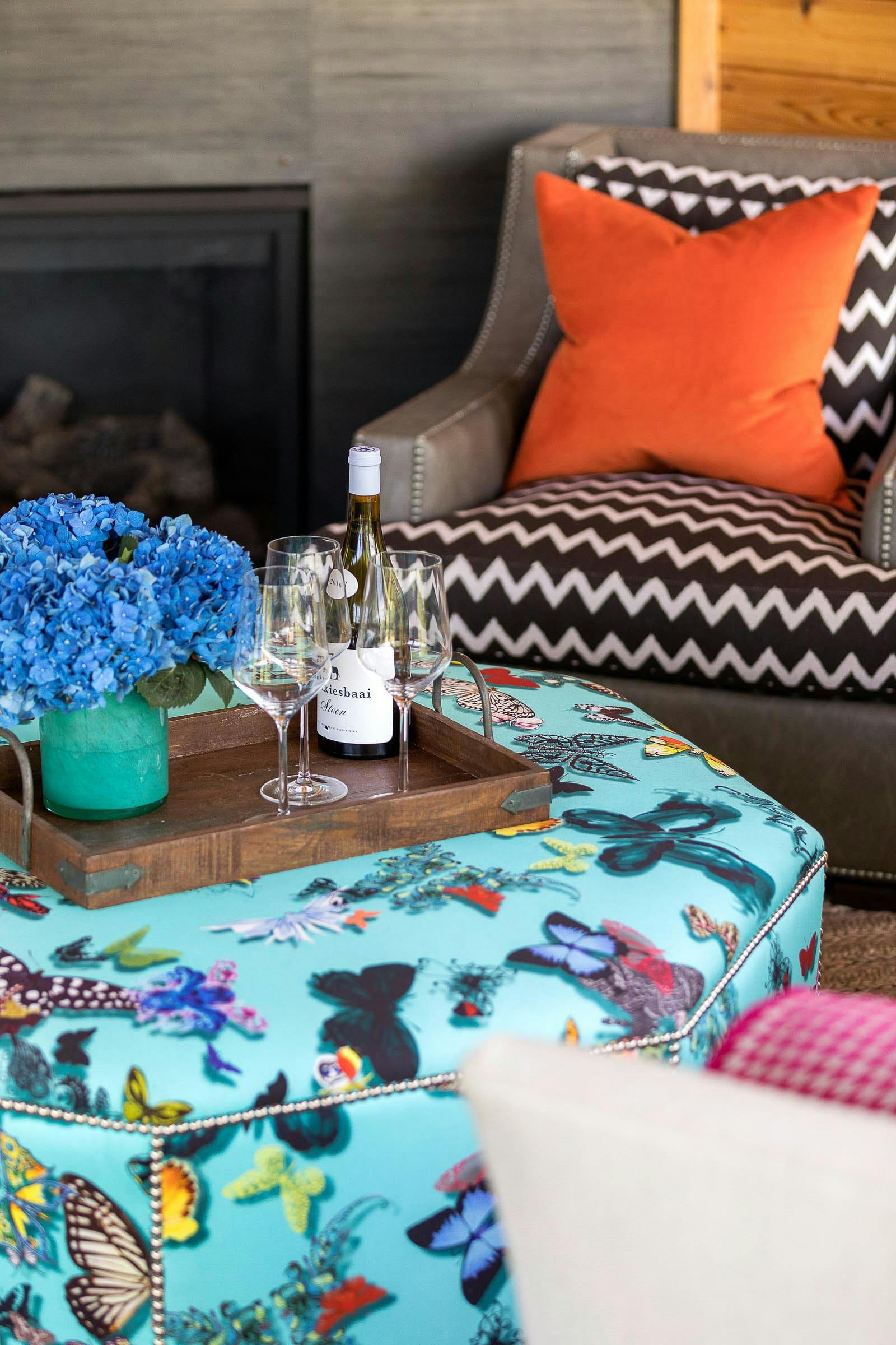 indoor/outdoor chair with two patterns, butterfly ottoman, wine and glasses