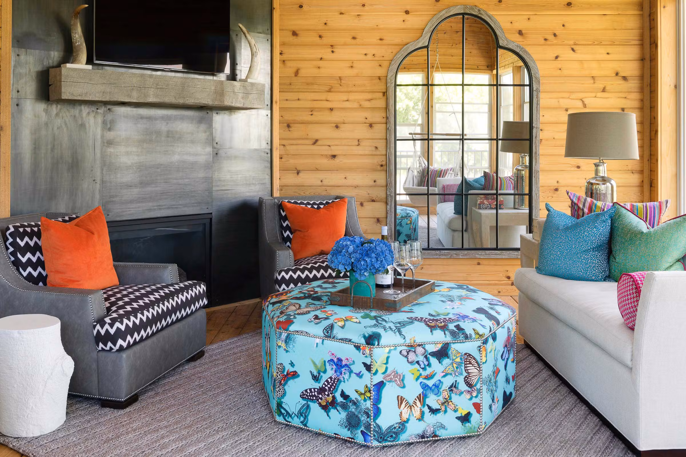 three season porch with colorful pops of colors and a butterfly ottoman