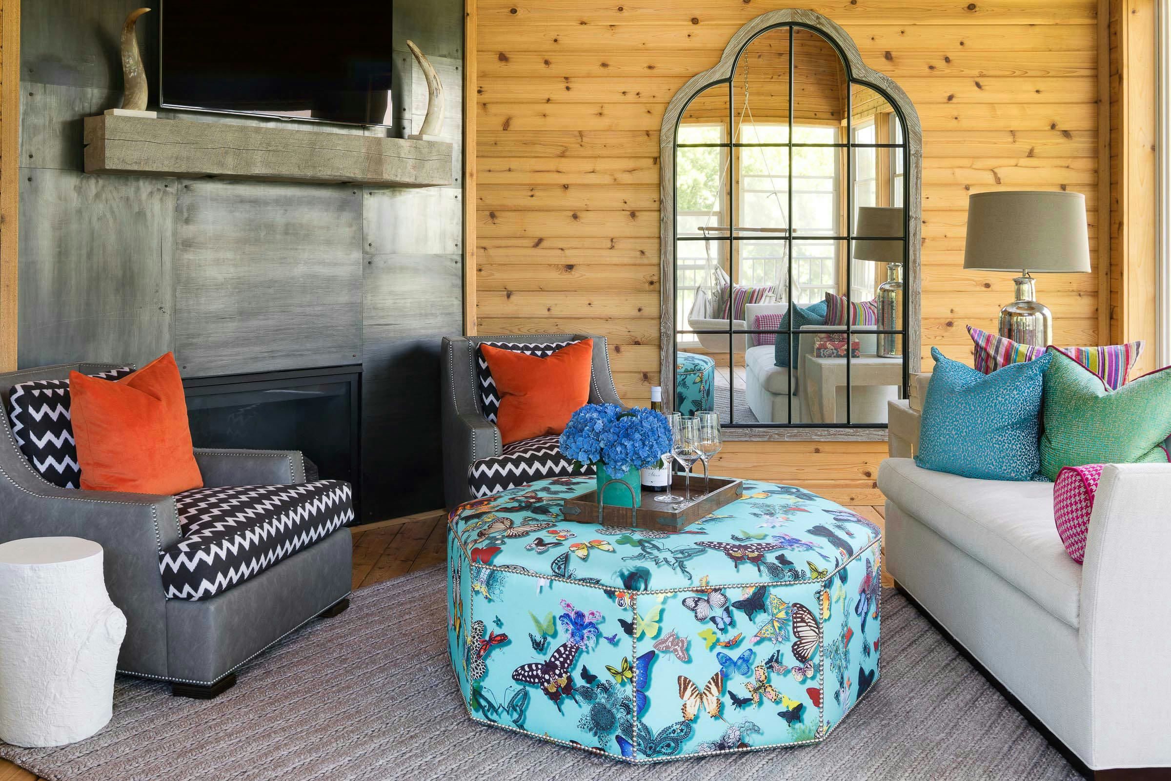 three season porch with colorful pops of colors and a butterfly ottoman