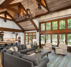 high ceilings with beams in the great room and kitchen